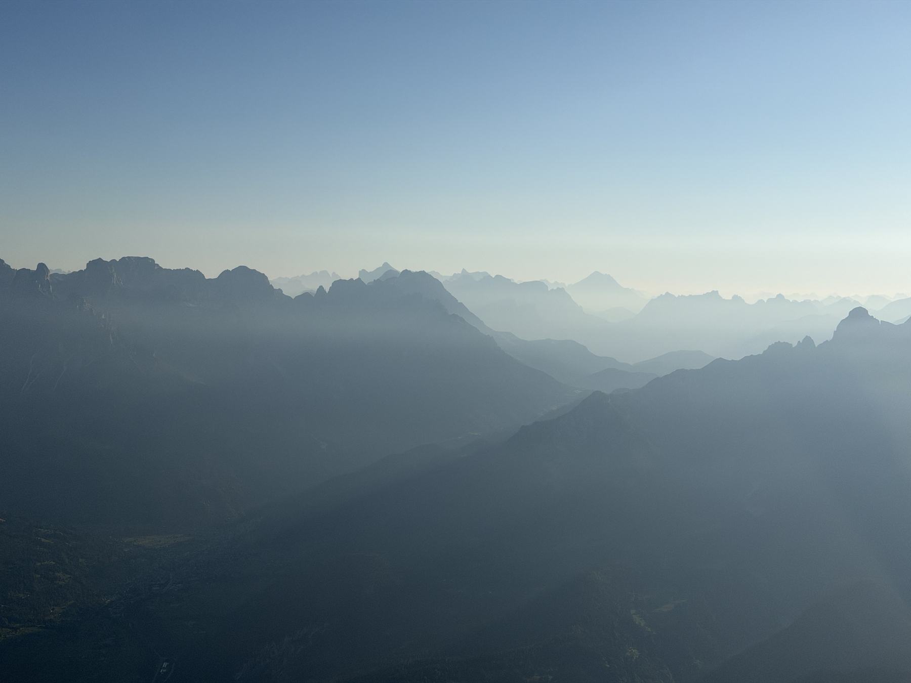 Ridgelines fading into haze, seen from the air